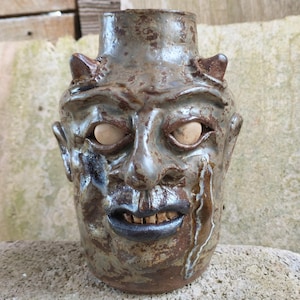 May include: A set of three ceramic canisters with lids, featuring a speckled white glaze and a minimalist design. The canisters vary in size, suitable for kitchen storage. The largest is approximately 20 cm tall.