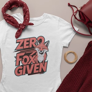 May include: White t-shirt with a red fox graphic and the text "ZERO FOX GIVEN" in red.