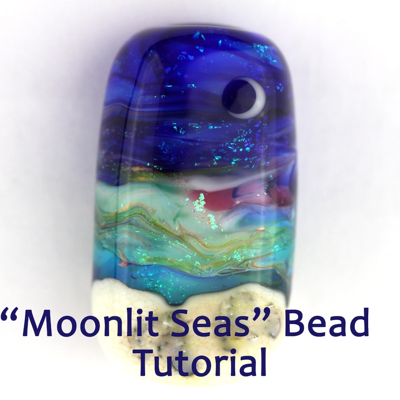 May include: A glass bead with a layered design depicting a moonlit seascape. The bead features a blue sky with a crescent moon, white clouds, and a turquoise ocean with white sand.