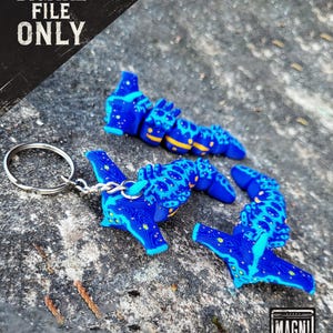 May include: Blue and yellow sea slug-shaped keychain charms with a circuit board design. The charms are attached to a silver keyring. The image also includes the text "DIGITAL FILE ONLY" and the "MAGNI MODELS" logo.
