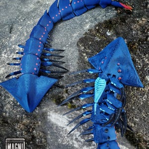 May include: A set of three ceramic mugs with a speckled, matte finish. The mugs are in shades of cream, light gray, and dark gray. Each mug has a simple, minimalist design, perfect for coffee or tea.