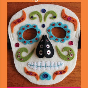 May include: A felt mask pattern for a Day of the Dead sugar skull. The mask is white with colorful felt details and sequins. The pattern includes instructions for making the mask.