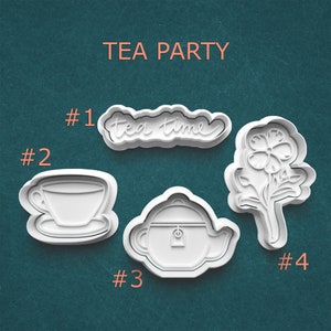 May include: White plastic cookie cutters in the shape of a teacup, teapot, flower, and the words "tea time". The phrase "TEA PARTY" is printed above the cookie cutters. The cutters are numbered 1 through 4.