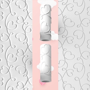 May include: White paint roller with a heart and swirl design. The roller is shown against a pink background with white clouds. The roller is also shown creating the pattern on a white surface.