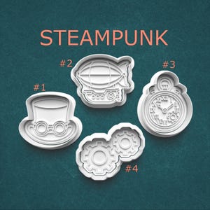 May include: Steampunk-themed cookie cutters. The set includes a top hat with goggles, an airship, a pocket watch, and two interlocking gears. The word "STEAMPUNK" is printed in orange above the cutters. The cutters are white and set against a teal background.