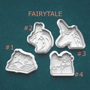 May include: Four white plastic cookie cutters with fairytale themes. The cutters include an open book with stars, a dragon's head, a unicorn head, and a wizard. The word "FAIRYTALE" is printed above the cutters.