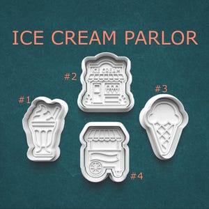 May include: Four white plastic cookie cutters in the shape of ice cream treats. The cutters include a sundae, an ice cream shop, an ice cream cone, and an ice cream cart. The words "ICE CREAM PARLOR" are printed at the top.