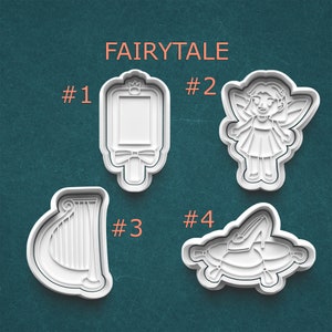 May include: Four white plastic cookie cutters with a fairytale theme. The cutters include a picture frame, a fairy, a harp, and a slipper on a pillow. The word "FAIRYTALE" is printed above the cutters.