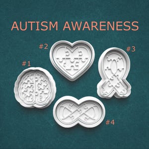 May include: Four white cookie cutters in various shapes: a brain, a heart, a ribbon, and an infinity symbol. Each cutter features a puzzle piece design. The words "AUTISM AWARENESS" are displayed in pink at the top of the image.