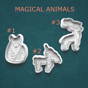 May include: Three white plastic cookie cutters in the shapes of magical animals: a fox, a unicorn, and a deer. The text "MAGICAL ANIMALS" is at the top. Each cutter is labeled with a number.