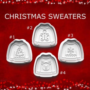 May include: Four white plastic cookie cutters shaped like sweaters, labeled #1 through #4. Each features a different embossed design: a Christmas tree, a gingerbread person, a snowflake, and a reindeer. The text CHRISTMAS SWEATERS is visible.