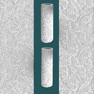 May include: White cylindrical vase with a detailed tree of life design. The vase is set against a teal background, with a textured white floral pattern on either side. The vase is approximately 10 inches tall.