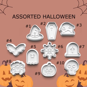 May include: Assorted Halloween-themed cookie cutters in white plastic. Designs include a witch hat, coffin, tombstone, bat, ghost, spiderweb, pumpkin, and skull. The text "ASSORTED HALLOWEEN" is at the top.