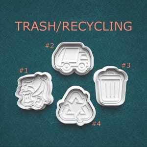 May include: Four white plastic cookie cutters with a trash and recycling theme. The cutters include a garbage truck, a recycling symbol, a trash can, and a piece of discarded food. The words "TRASH/RECYCLING" are printed in pink.