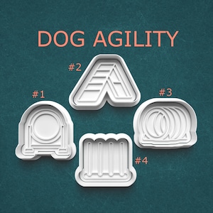 May include: White plastic dog agility course cookie cutters. The image shows four different shapes: a hoop, an A-frame, a set of weave poles, and a set of tire jumps. The words "DOG AGILITY" are in orange text at the top.