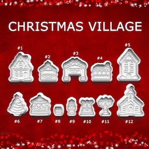 May include: A set of twelve white plastic cookie cutters labeled CHRISTMAS VILLAGE, featuring shapes of houses, a market stall, a carousel, a nutcracker, a church, and a street lamp, arranged in two rows against a dark red background.
