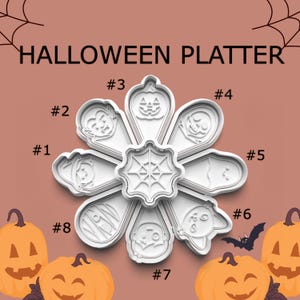 May include: White Halloween platter cookie cutters in various shapes, including a pumpkin, vampire, mummy, and zombie. The platter is centered with a spiderweb design. The text "HALLOWEEN PLATTER" is at the top.