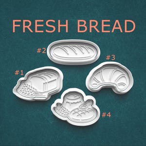 May include: A set of three ceramic mugs with a speckled, matte finish. The mugs are in shades of cream, light gray, and dark gray. Each mug has a simple, minimalist design, perfect for coffee or tea.