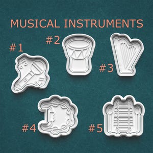 May include: White plastic cookie cutters in the shapes of musical instruments, including a microphone, drum, harp, tambourine, and xylophone. The words "MUSICAL INSTRUMENTS" are printed in orange at the top of the image.