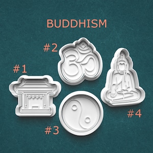 May include: Four white plastic cookie cutters with Buddhist symbols: a temple, an Om symbol, a Yin-Yang symbol, and a seated Buddha. The word "BUDDHISM" is printed in orange above the cutters. Numbers 1-4 are printed next to each cutter.