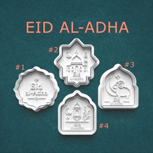 May include: Four white cookie cutters with Eid al-Adha designs. The cutters include a mosque, a crescent moon, a ram, and a lantern. The text "EID AL-ADHA" is in orange above the cutters.
