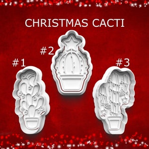 May include: Three white plastic Christmas cactus cookie cutters. The cutters are in the shape of cacti with different designs, including a star and string lights. The text "CHRISTMAS CACTI" is at the top.