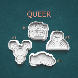 May include: A set of three ceramic mugs with a speckled, matte finish. The mugs are in shades of cream, light gray, and dark gray. Each mug has a simple, minimalist design, perfect for coffee or tea.