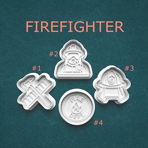 May include: Four white plastic cookie cutters with a firefighter theme. The cutters include crossed axes, a firefighter in gear, a helmet, and a fire department emblem. The word "FIREFIGHTER" is printed in orange at the top.