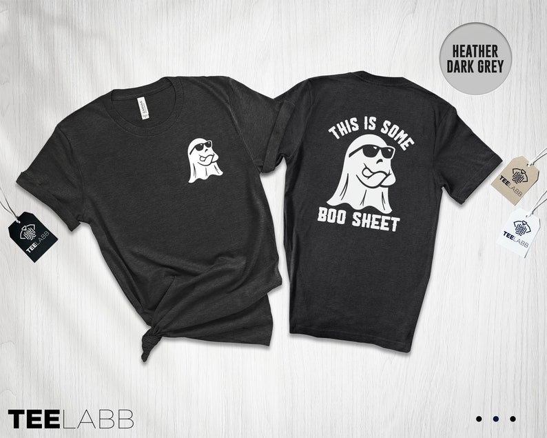 以下が含まれることがあります： ヘザーダークグレーのTシャツ。背面にはサングラスをかけた白い幽霊と「This is some boo sheet」の文字がプリントされています。前面には、サングラスをかけた小さな白い幽霊がプリントされています。