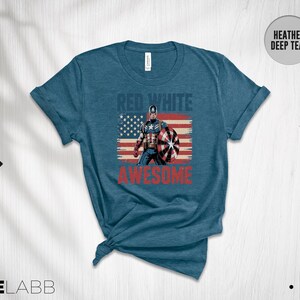 May include: A heather deep teal short-sleeve t-shirt featuring a graphic of Captain America in front of a distressed American flag. The text RED WHITE is printed in blue above the character, and the word AWESOME is printed in red below.