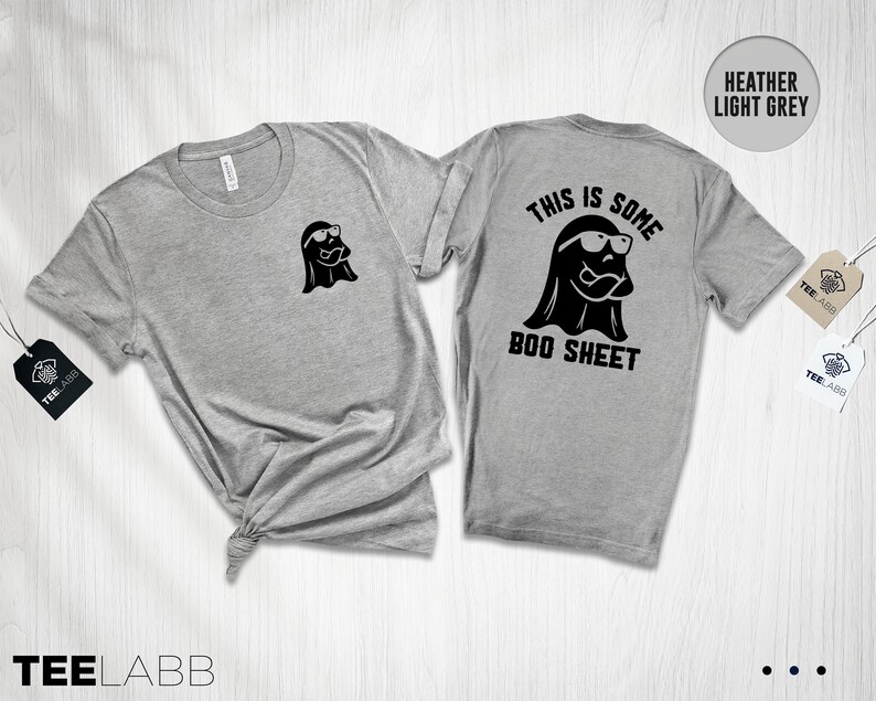 以下が含まれることがあります： ヘザーライトグレーのTシャツに、サングラスをかけた黒い幽霊と「This is some boo sheet」という文字が書かれています。
