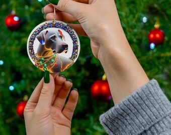 May include: A white ceramic Christmas ornament featuring a white dog with colorful lights and beads around its neck. The ornament is round and has a gold rim.