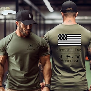 May include: A green t-shirt with a black American flag and the text "Memorial Day - Honoring All Who Served - MURPH '24" on the back. The front of the shirt has a black silhouette of a military helmet and the text "MURPH '24".