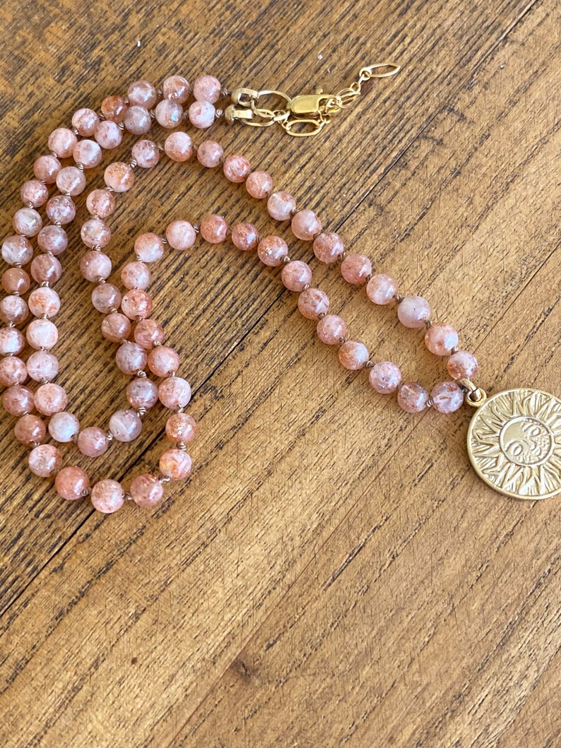 Sun pendant necklace on hand knotted silk with lepidocrocite strawberry-orange stones.