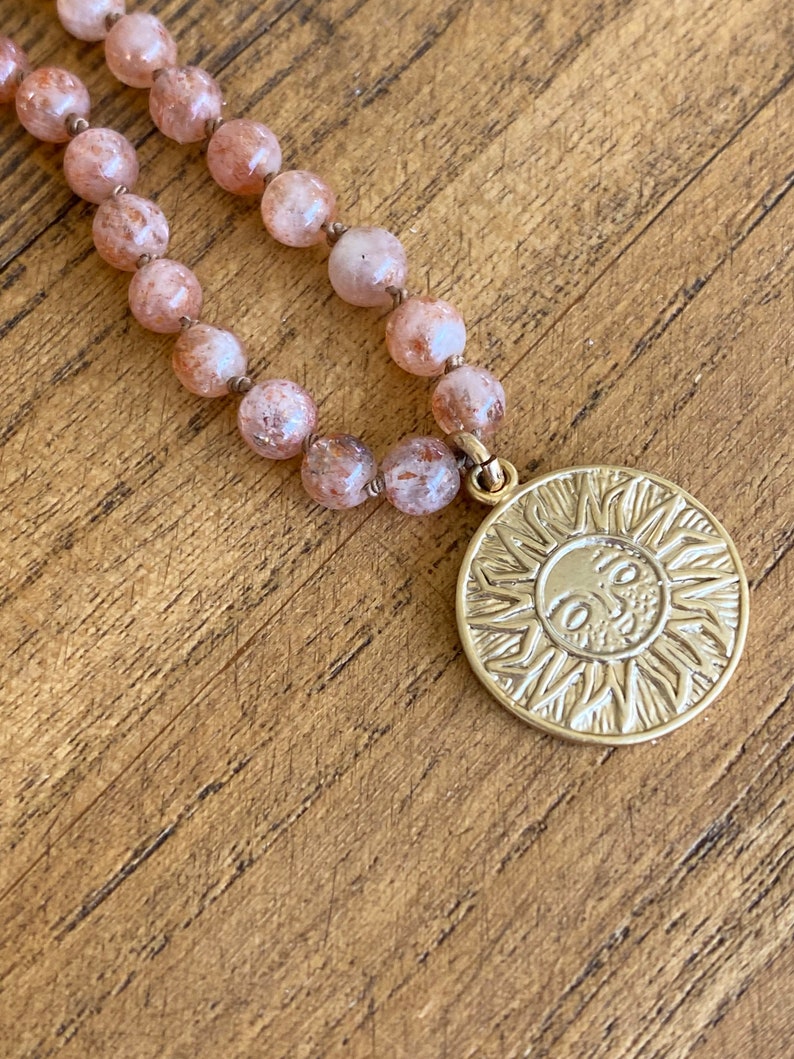 Sun pendant necklace on hand knotted silk with lepidocrocite strawberry-orange stones.