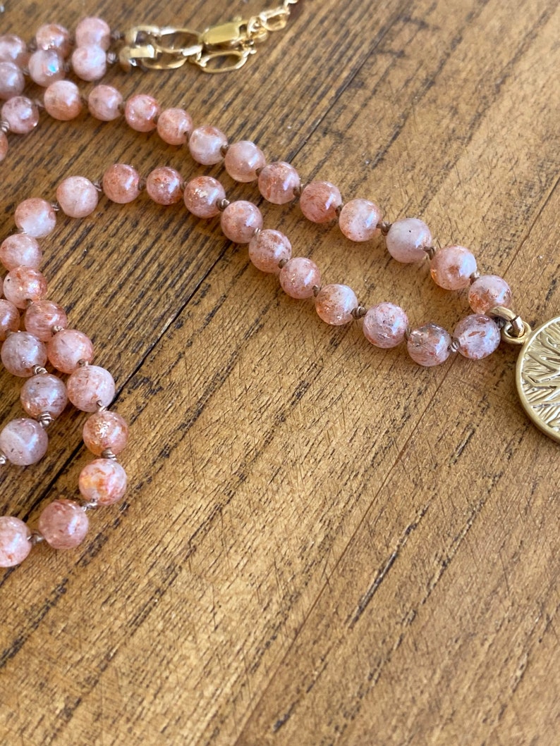 Sun pendant necklace on hand knotted silk with lepidocrocite strawberry-orange stones.