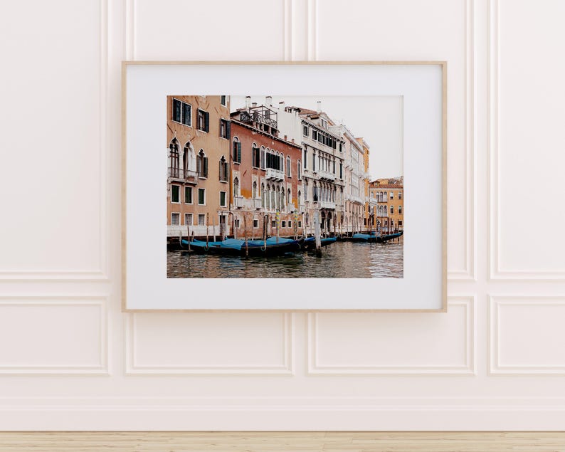 May include: A photograph of a canal in Venice, Italy. The canal is lined with colorful buildings and there are several gondolas in the water.