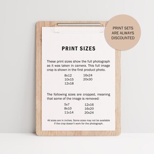 May include: A brown wooden clipboard with a white paper insert listing different print sizes in inches. The paper lists full image sizes and cropped sizes. The text "Print Sets Are Always Discounted" is written on a light brown circle in the top right corner.
