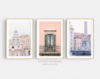 May include: Set of three framed art prints featuring architectural scenes. The prints showcase a domed building, a balcony with green shutters, and a fountain with an obelisk. The frames are gold, and the overall aesthetic is soft and pastel.