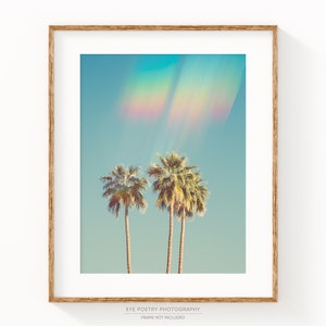 May include: A framed art print featuring two palm trees against a turquoise sky with a rainbow effect. The print is in a wooden frame and includes the text "EYE POETRY PHOTOGRAPHY" and "FRAME NOT INCLUDED".