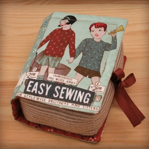 May include: A vintage-style book cover featuring a red and blue illustration of two children. The book is titled "Easy Sewing for Stylewise Brothers and Sisters". The cover is made of fabric and has a red ribbon tied around it.