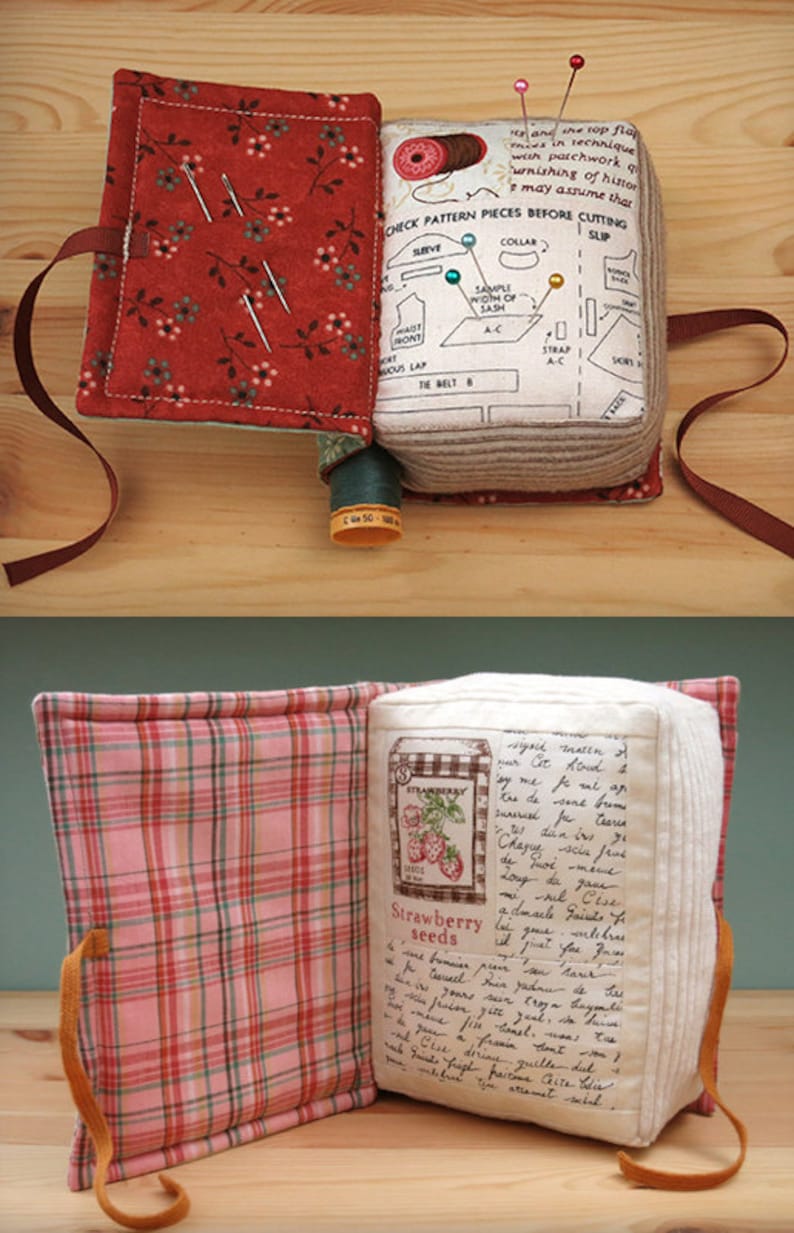 May include: Two fabric-covered books with a plaid and floral pattern. The books are open and have a handwritten message inside. The books are filled with sewing supplies, including needles, thread, and pins.