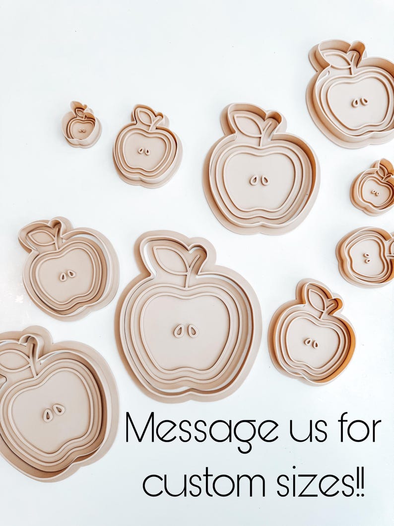 May include: Set of nine beige plastic apple-shaped cookie cutters of various sizes. The largest cutter is about 3 inches in diameter. Message us for custom sizes!