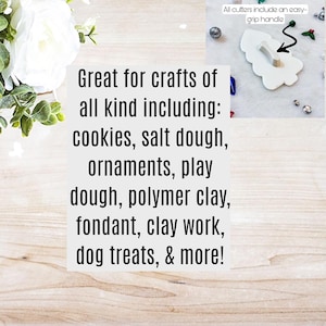 May include: White plastic cookie cutter shaped like a Christmas tree with a green holly sprig and red berries. The cutter has a black handle. Text on the image reads: "Great for crafts of all kind including: cookies, salt dough, ornaments, play dough, polymer clay, fondant, clay work, dog treats, & more!" and "All cutters include an easy-grip handle."