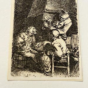 May include: A black and white etching depicts a scene with several figures. One figure, seated, has a monkey-like face. Two other figures stand, and another sits on a chair. The etching has a detailed, cross-hatch style.