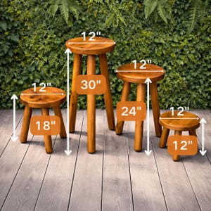 May include: Four wooden stools of varying heights. The tallest stool is 30 inches high, with a 12-inch diameter seat. The other stools are 24 inches, 18 inches, and 12 inches high, all with 12-inch diameter seats. The stools are made of light brown wood.