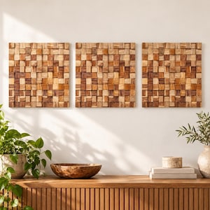 May include: Three square wall art panels composed of small, individual wooden blocks in varying shades of light, medium, and dark brown. Each panel features a textured, grid-like surface with protruding and recessed squares creating depth.
