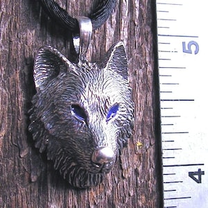 Timber Wolf Pendant With Blue Eyes In Sterling Silver