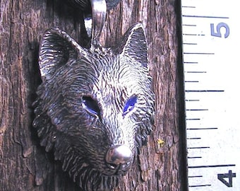 Timber Wolf Pendant With Blue Eyes In Sterling Silver