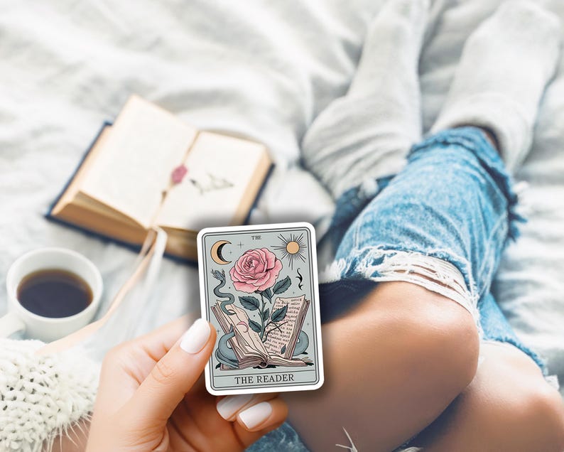 May include: A tarot card with a blue background and a pink rose with a snake wrapped around it. The card reads "The Reader" at the bottom.